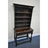 A OAK DRESSER INCORPORATING 18TH CENTURY OR EARLIER TIMBERS, the oak top with five open shelves over