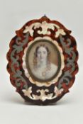 A VICTORIAN HEAD AND SHOULDERS IVORY PORTRAIT MINIATURE OF A YOUNG WOMAN, her brown hair in