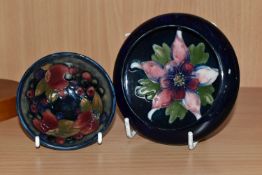 TWO PIECES OF MOORCOFT POTTERY, comprising a Columbine dish with inverted rim, tube lined in