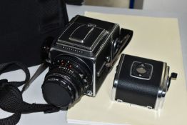 A HASSELBLAD 500C/M MEDIUM FORMAT FILM CAMERA fitted with a Carl Zeiss Planar 80mm f2.8 lens, two