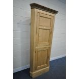 A VICTORIAN STYLE PINE FARM HOUSE KITCHEN CORNER CUPBOARD, made up of two panelled cupboard doors,