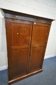 AN EDWARDIAN MAHOGANY AND INLAID WARDROBE, with overhanging cornice, double doors enclosing an