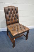 A BROWN LEATHER BUTTONED CHAIR