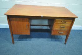 IN THE MANNER OF GORDON RUSSELL, a mid-century teak desk, with a single cupboard door, and three