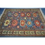 A LATE 19TH/EARLY 20TH CENTURY KAZAK WOOLLEN RUG, with ten medallions, blue field, and a