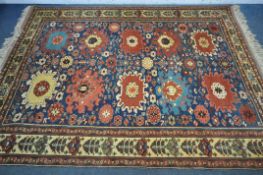 A LATE 19TH/EARLY 20TH CENTURY KAZAK WOOLLEN RUG, with ten medallions, blue field, and a