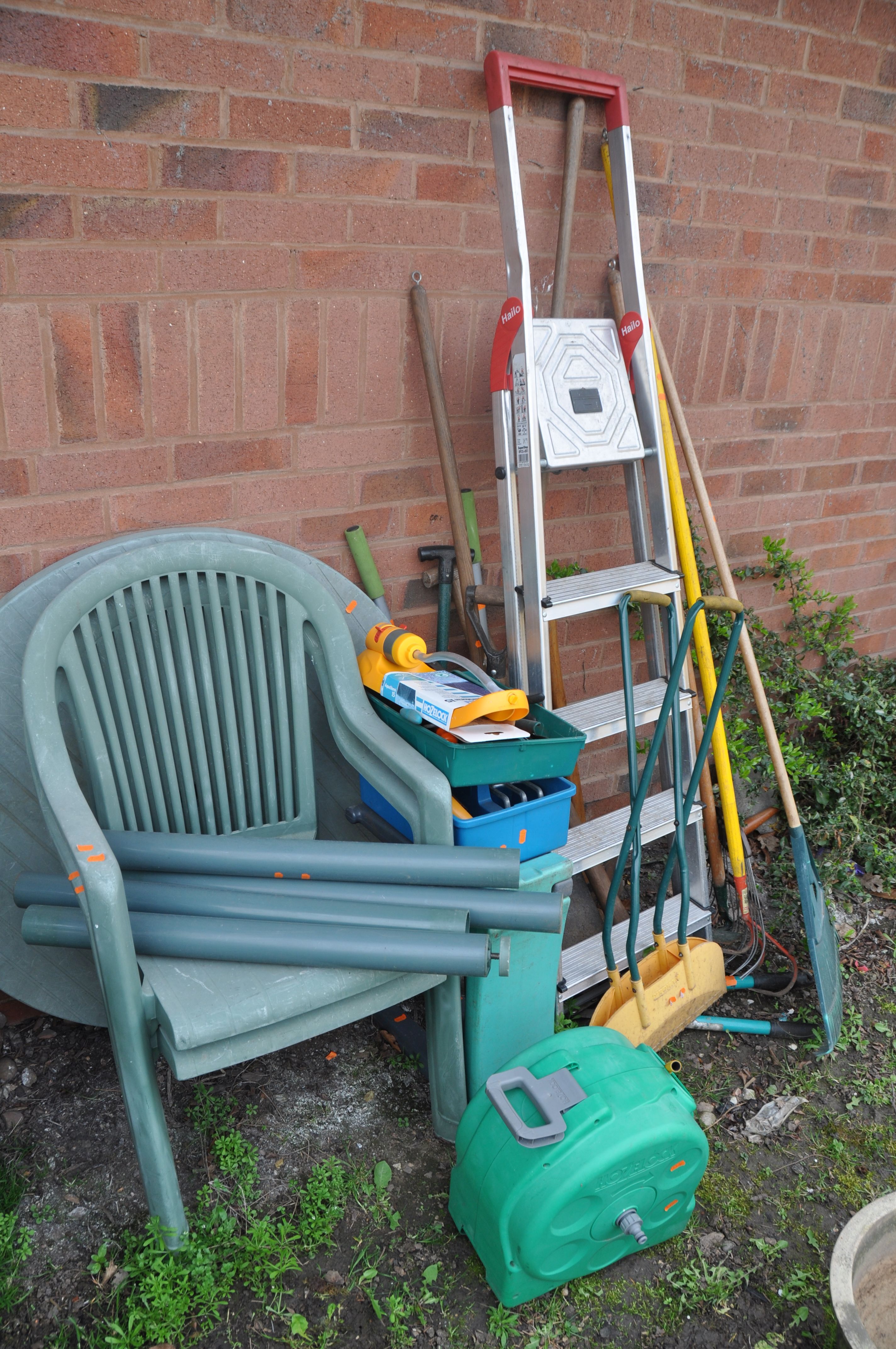 A SELECTION OF GARDEN ITEMS to include a plastic circular garden table with two chairs, a metal four