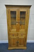 A SOLID OAK GLAZED CABINET, with two glass shelves and a two drawers over two cupboard doors,