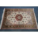 A FINE 20TH CENTURY SILK RUG, 400 knot count, decorated with foliage, vines and flower heads,