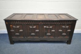 A LONG GEORGIAN OAK PANEL COFFER, with four Geometric panels, with a hinged storage to the left