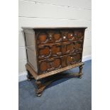 A JACOBEAN STYLE OAK TWO DOOR TV CABINET, on turned legs, united by a stretcher, width 91cm x