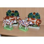 FOUR PIECES OF COW THEMED POTTERY, comprising two cow creamers with red and pink lustre patches,