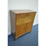 AN EARLY 20TH CENTURY BURR WALNUT COCKTAIL DRINKS CABINET, the opening door to reveal a rising