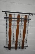 A WROUGHT IRON WALL HANGING COAT RACK, with detachable shoe shelf to top, and three wooden slats,