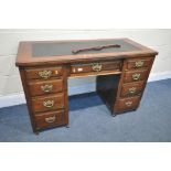 AN EDWARDIAN WALNUT KNEE HOLE DESK, with a later black finish writing surface and 9 draws on later