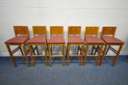 A SET OF SIX BEECH HIGH STOOLS, with red upholstery, height 107cm (condition - some marks to