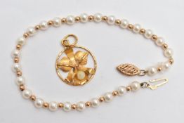 A YELLOW METAL PENDANT AND A CULTURED FRESH WATER PEARL BRACELET, a floral yellow metal pendant
