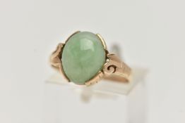 A 9CT GOLD JADE RING, jade cabochon collet set to the scrolling shoulders and polished band,