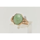 A 9CT GOLD JADE RING, jade cabochon collet set to the scrolling shoulders and polished band,