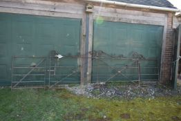 A SET OF LARGE VINTAGE GATES including a 310cm wide gate with scrolled pedaments, x braced with