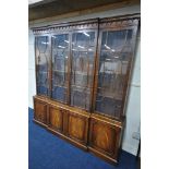 A REPRODUX MAHOGANY BREAKFRONT BOOKCASE, with four astragal glazed doors that's enclosing adjustable