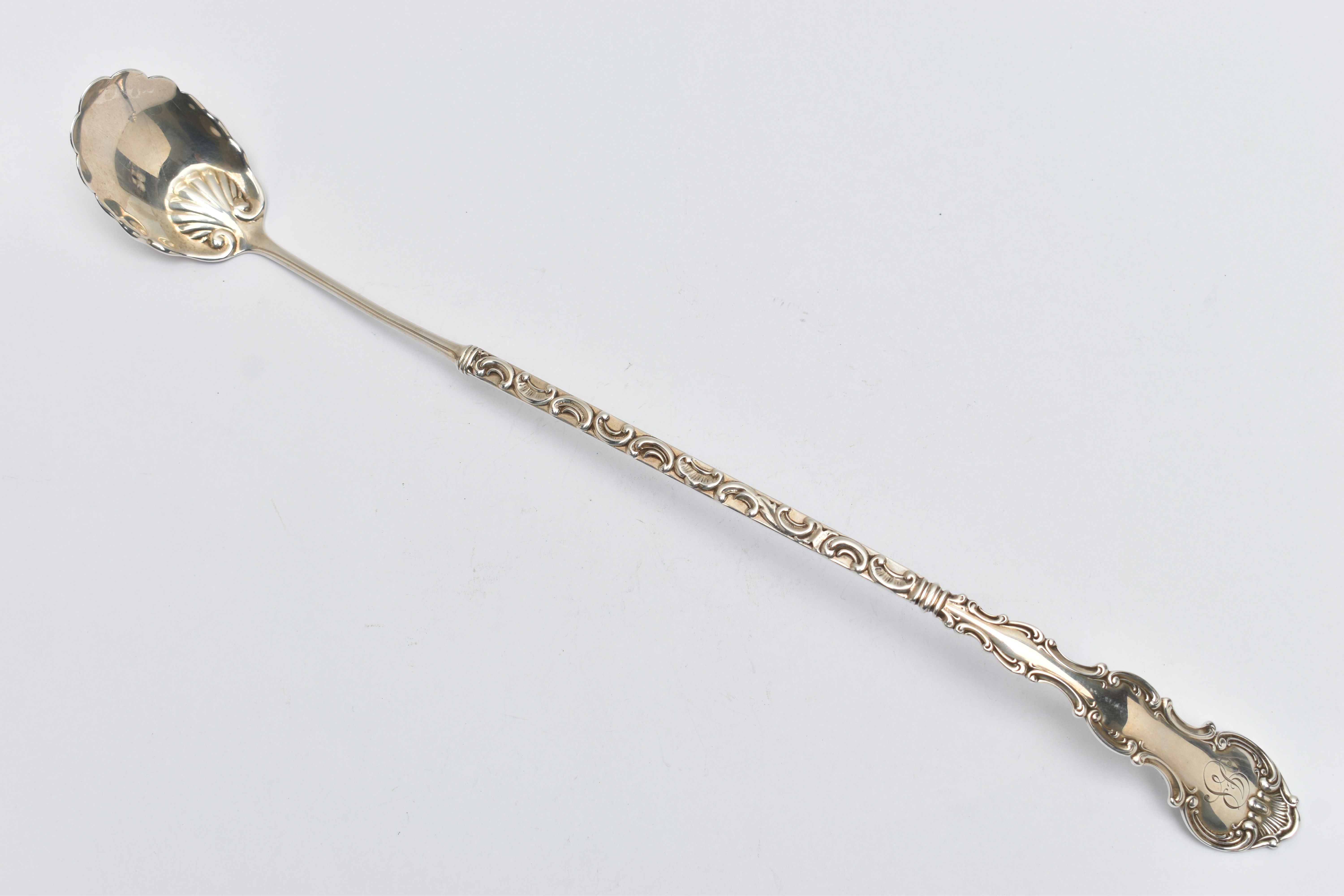 AN AMERICAN STERLING SILVER LADLE, the handle cast with scroll and shell decoration and engraved