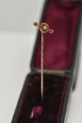 AN EARLY 20TH CENTURY DIAMOND AND GEM STICKPIN, designed as a central old cut diamond within a