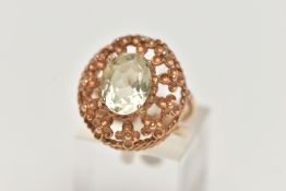 A 9CT GOLD GEM SET RING, set with an oval cut pale green stone assessed as spinel, in a four claw