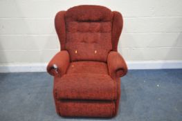 A RED UPHOLSTERED ARMCAHIR
