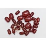 A SMALL BAG OF LOOSE CHERRY AMBER BAKELITE BARREL BEADS, graduated oval beads, visible swirls