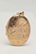 A LARGE OVAL LOCKET, floral design to the front, opens to reveal two photo compartments, approximate