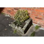 A VINTAGE SANDSTONE PUMP TROUGH width 54cm depth 57cm height 30cm at highest point with soil and