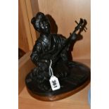 A JAPANESE BRONZE OF A GEISHA KNEELING AND PLAYING A SHAMISEN, cast as singing and with book of