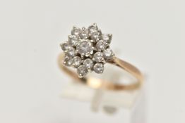A 9CT GOLD CLUSTER RING, sixteen circular cut cubic zirconia stones, prong set in yellow gold,