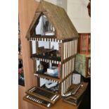 A FOUR STOREY TUDOR WOODEN DOLLS HOUSE, made by Robert Stubbs, model no. F1, detachable magnetic