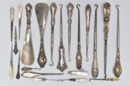 TWELVE SILVER HANDLED BUTTON HOOKS AND SHOE HORNS, together with six mother of pearl handled