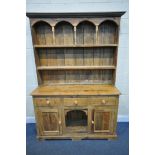 A VICTORIAN STYLE PINE DRESSER, with two shelves over cupboard with three drawers, flanked by two