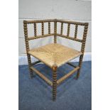 A WILLIAM MORRIS STYLE BEECH BOBBIN TURNED CORNER CHAIR, with a rush seat (condition:- worn