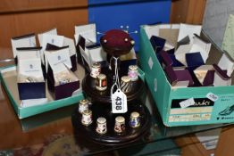 A COLLECTION OF ROYAL CROWN DERBY THIMBLES, comprising fifteen boxed thimbles, and a wooden stand
