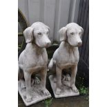 A PAIR OF COMPOSITE GARDEN SITTING DOG STATUES