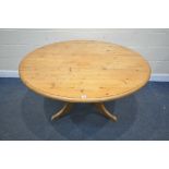 A MODERN PINE CIRCULAR TABLE, on a pedestal and tripod legs, diameter 137cm x height 73cm (