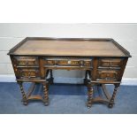 AN EARLY 20TH CENTURY OAK PEDASTAL SIDEBOARD, with a gallery top over five drawers with brass drop