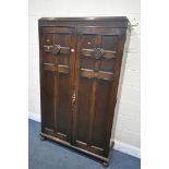 AN EARLY 20TH CENTURY MAPLE AND CO OF LONDON, OAK TWO DOOR HALL ROBE/CUPBOARD, enclosing a shelf