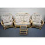 A WICKER CONSERVATORY SUITE, comprising a sofa, two armchairs, pouffe, and a coffee table (