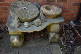 A COLLECTION OF VINTAGE SANDSTONE BLOCKS AND PLATE FORMING A RUSTIC TABLE width 108cm depth 74cm