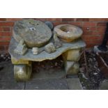 A COLLECTION OF VINTAGE SANDSTONE BLOCKS AND PLATE FORMING A RUSTIC TABLE width 108cm depth 74cm