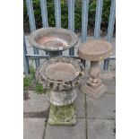 A WEATHERED COMPOSITE COMPAGNA GARDEN URN measuring diameter 44cm x height 63cm, along with a