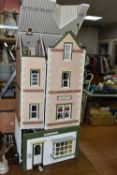 A LARGE WOODEN DOLLS HOUSE 'POPPIES FASHIONS & HABERDASHERY' AND 'WILLOW TEA ROOMS', made by the