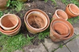 A COLLECTION OF TEN WEATHERED TERRACOTTA POTS of all different sizes largest pot diameter 43cm (10)