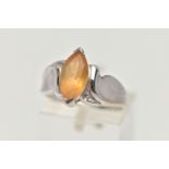 A 9CT WHITE GOLD TOPAZ RING, designed with a marquise cut yellow topaz, to scrolling shoulders and